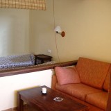 Holiday Bungalow Studio. Living area with sofa, satellite TV and 2 single beds - 1