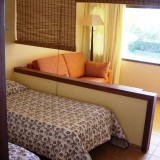 Holiday Bungalow Studio. Living area with sofa, satellite TV and 2 single beds - 1
